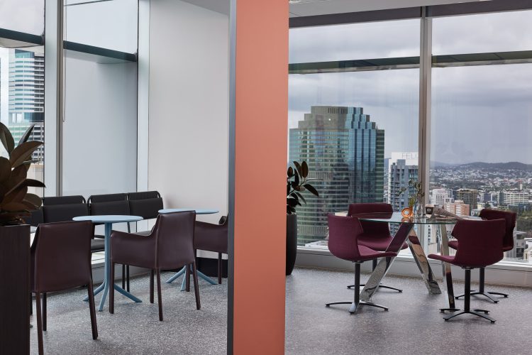 Office dining and meeting spaces in front of cityscape views